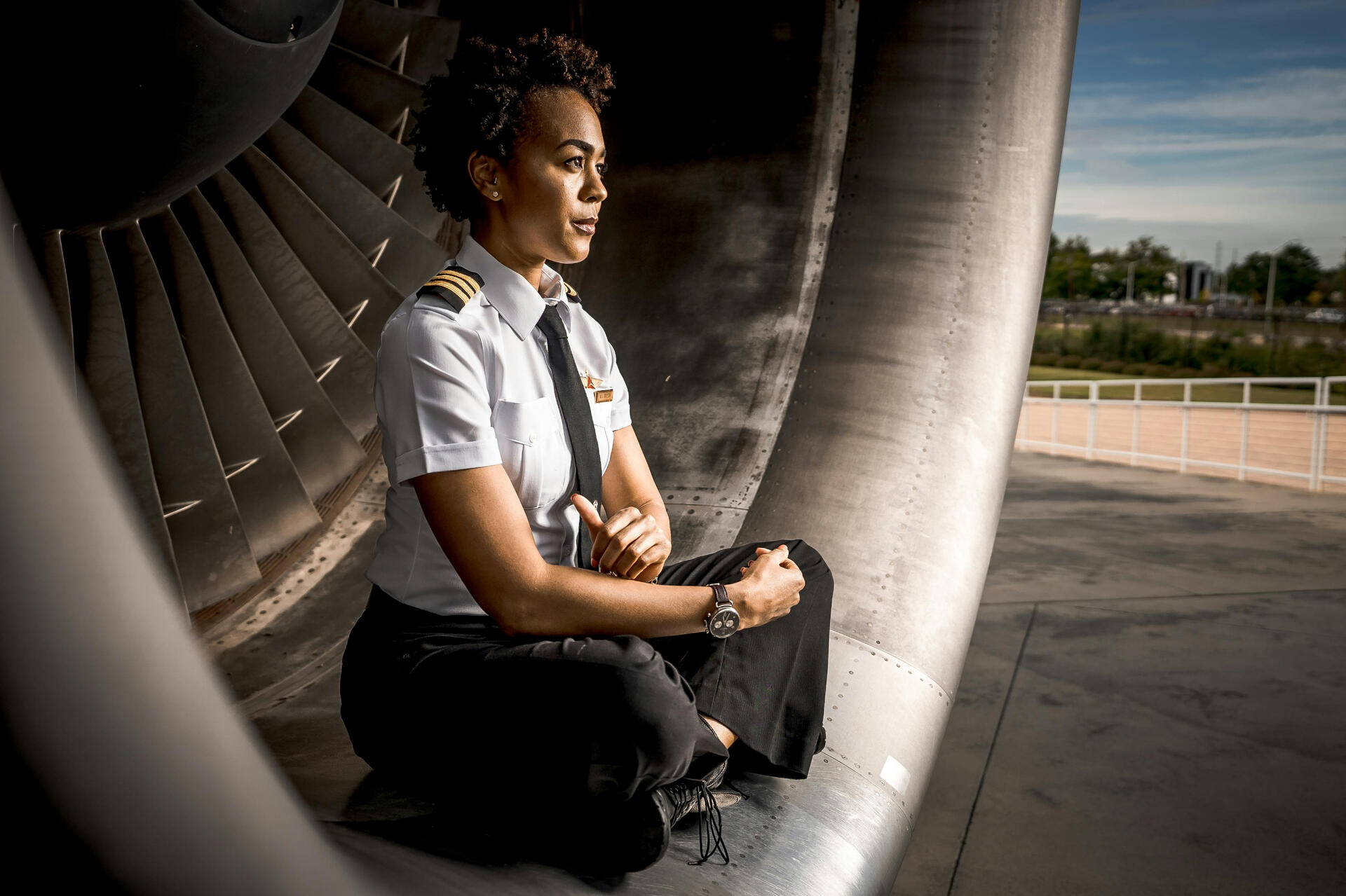 Pilot Woman Wearing Uniform Sitting inside an Aircraft Engine Intake